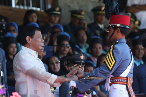 President Rodrigo Duterte awards the Philippine Navy Saber to Philippine Military Academy (PMA) 'Salaknib' Class of 2017 top graduate Cadet First Class Rovi Mairel Valino Martinez during the Commencement Exercises at the Fort General Gregorio H. del Pilar in Baguio City on March 12, 2017.  (Photo courtesy Presidential Communications)