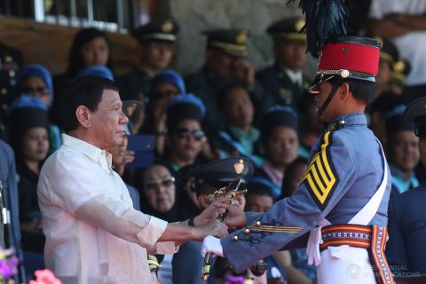 President Rodrigo Duterte awards the Philippine Navy Saber to Philippine Military Academy (PMA) 'Salaknib' Class of 2017 top graduate Cadet First Class Rovi Mairel Valino Martinez during the Commencement Exercises at the Fort General Gregorio H. del Pilar in Baguio City on March 12, 2017.  (Photo courtesy Presidential Communications)