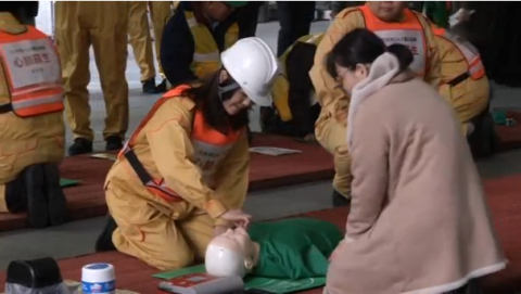 About 100 people participate in a disaster training drill in downtown Tokyo before the sixth anniversary of the Fukushima nuclear plant meltdown triggered by a massive earthquake and tsunami.(photo grabbed from Reuters video)