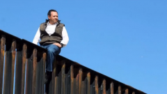 A Mexican congressman climbs the fence separating the U.S. and his country to show what he says is the futility of President Donald Trump's plan.(photo grabbed from Reuters video)