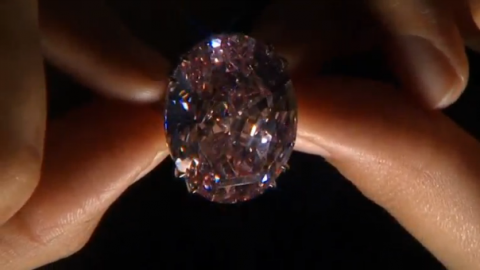 A 59.60-carat diamond known as "The Pink Star" is returning to auction next month and could fetch a record $60 million, three years since it was sold for even more - only for the buyer to pull out of the deal.(photo grabbed from Reuters video)