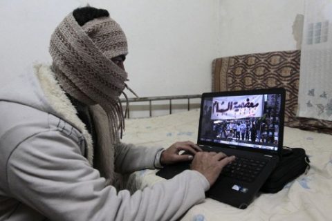 (FILES) This file photo taken on March 22, 2012 shows shows a Syrian refugee from Damascus, who identified himself as Abu Shadi, using his computer to check on news from Syria in his bedroom at a house he rents from a Jordanian family in the Nazzal district of Amman, Jordan. The United States is poised to ban large electronic devices such as laptops or cameras on board flights from up to a dozen Middle East nations, according to two airlines from the region and media reports, March 20, 2017. The move would mark the latest attempt by President Donald Trump's administration to tighten security at US borders, after its bid to curb travel from a group of Muslim majority nations was twice blocked by the courts. / AFP PHOTO / KHALIL MAZRAAWI