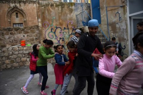 Syrian children play as they attend a circus class on March 19, 2017, in Mardin. There is laughter, excitement and a sense of joyful chaos. Some children are perched on stilts, others are spinning plates or happily performing aerial dances. But this is not the big top circus in a major city but a house in southeastern Turkey where Syrian refugee children are learning circus tricks in an innovative programme to help integrate into their foreign host country. The Her Yerde Sanat association ('art is everywhere' in Turkish) is working with 120 young people aged between three and 20, 80 of whom are Syrians and the rest are Turks. / AFP PHOTO / BULENT KILIC