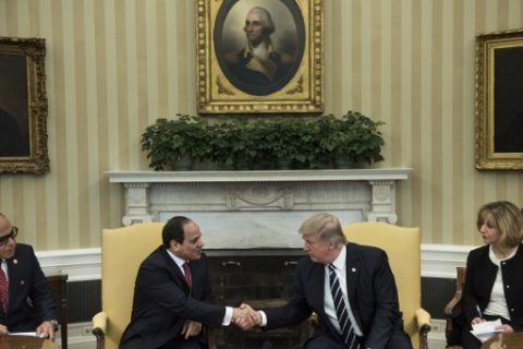 Translators watch as Egypt's President Abdel Fattah al-Sisi (L) and US President Donald Trump shake hands in the Oval Office before a meeting at the White House April 3, 2017 in Washington, DC. / AFP PHOTO / Brendan Smialowski