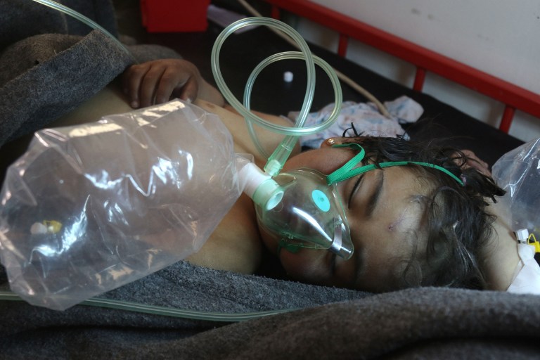A Syrian child receives treatment following a suspected toxic gas attack in Khan Sheikhun, a rebel-held town in the northwestern Syrian Idlib province, on April 4, 2017. Warplanes carried out a suspected toxic gas attack that killed at least 35 people including several children, a monitoring group said. The Syrian Observatory for Human Rights said those killed in the town of Khan Sheikhun, in Idlib province, had died from the effects of the gas, adding that dozens more suffered respiratory problems and other symptoms. / AFP PHOTO / Mohamed al-Bakour