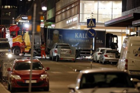 The stolen truck, which was driven through a crowd outside a department in Stockholm on April 7, 2017, is towed on April 8, 2017. A massive manhunt was underway for the driver of the stolen truck that ploughed into the crowd, killing four and injuring 15, Swedish police said. / AFP PHOTO / Odd ANDERSEN