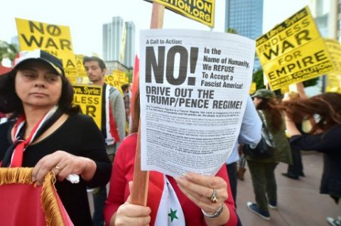 Demonstrators protest US air strikes against Syria in Los Angeles on April 7, 2017. The United States on April 7 warned it was ready to hit Syria again after targeting an air base in a strike that infuriated Moscow and fueled calls for a new diplomatic push to end the six-year war. / AFP PHOTO / FREDERIC J. BROWN