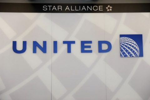 (FILES) This file photo taken on August 13, 2013 shows a United Airlines logobehind the ticket counter at Chicago's O'Hare airport. Social media anger sparked by footage of United Airlines forcibly removing a passenger from an overbooked flight showed no signs of abating on April 11, 2017, with calls for a boycott of the US carrier. The videos taken on the plane and posted to Twitter showed the man, reportedly identified by another passenger as ethnically Chinese, being forcibly pulled screaming from his seat by three security personnel.United addressed the incident in a statement posted on its website on April 10, 2017. "This is an upsetting event to all of us," said chief executive Oscar Munoz, noting that the airline was conducting a "detailed review of what happened."  / AFP PHOTO / MIRA OBERMAN