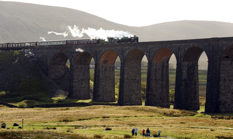 (FILES) This file photo taken on October 03, 2009 shows the Peppercorn Class A1 60163 Tornado steam train traveling over the Ribblehead Viaduct in Ribblehead, nortern England, for the first time on October 3, 2009. Tornado, a Peppercorn-class A1 steam locomotive, clocked 100 miles (161 kilometres) per hour on Britain's mainline railway network for the first time in almost 50 years on April 12, 2017. / AFP PHOTO / PAUL ELLIS