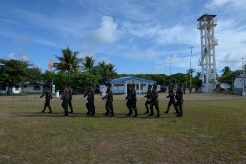 Philippine soldiers march after a welcoming ceremony during the visit of Defense Secretary Delfin Lorenzana to Thitu island in Spratlys on April 21, 2017. A group of Filipino fishermen have accused China's coast guard of shooting at their vessel in disputed South China waters, Philippne authorities said April 21. / AFP PHOTO / TED ALJIBE