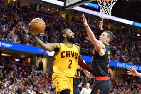CLEVELAND, OH - APRIL 7: Kyrie Irving #2 of the Cleveland Cavaliers passes around Ryan Kelly #30 of the Atlanta Hawks during the first half at Quicken Loans Arena on April 7, 2017 in Cleveland, Ohio. NOTE TO USER: User expressly acknowledges and agrees that, by downloading and/or using this photograph, user is consenting to the terms and conditions of the Getty Images License Agreement.   Jason Miller/Getty Images/AFP