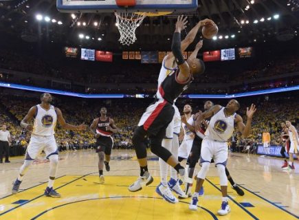 OAKLAND, CA - APRIL 16: JaVale McGee #1 of the Golden State Warriors blocks the shot of Damian Lillard #0 of the Portland Trail Blazers in the third quarter during Game One of the first round of the 2017 NBA Playoffs at ORACLE Arena on April 16, 2017 in Oakland, California. NOTE TO USER: User expressly acknowledges and agrees that, by downloading and or using this photograph, User is consenting to the terms and conditions of the Getty Images License Agreement. Thearon W. Henderson/Getty Images/AFP