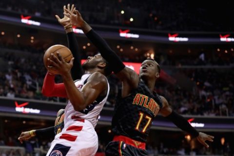 WASHINGTON, DC - APRIL 19: John Wall #2 of the Washington Wizards puts up a shot in front of Dennis Schroder #17 of the Atlanta Hawks in Game Two of the Eastern Conference Quarterfinals during the 2017 NBA Playoffs at Verizon Center on April 19, 2017 in Washington, DC. NOTE TO USER: User expressly acknowledges and agrees that, by downloading and or using this photograph, User is consenting to the terms and conditions of the Getty Images License Agreement.   Rob Carr/Getty Images/AFP