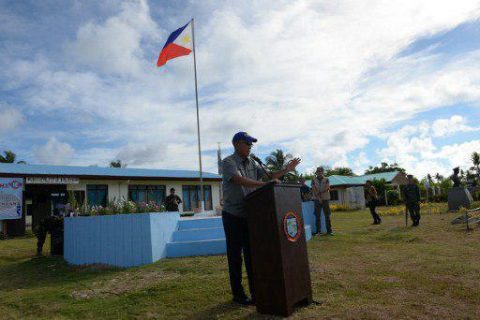 Philippine Defense Secretary Delfin Lorenzana gestures as he delivers his speech during a visit to Thitu island in Spratlys on April 21, 2017. A group of Filipino fishermen have accused China's coast guard of shooting at their vessel in disputed South China waters, Philippne authorities said April 21. TED ALJIBE / AFP