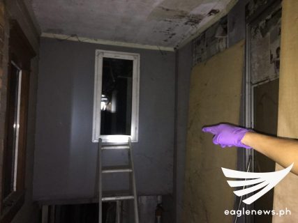 Entrance to the room where the cache of high-powered firearms and ammunition was found. It looks like a window at first glance.