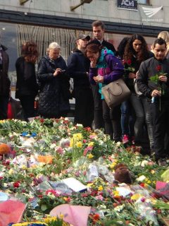 A woman cries as she stands near flowers laid down for the victims of the Stockholm terror truck attack.  (Photo by Fritzie Joy Pijana, Eagle News Service)