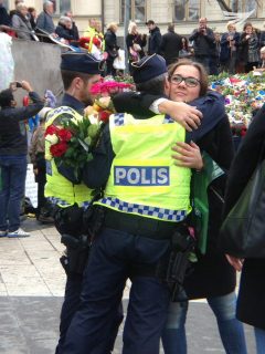 Overflowing of emotion as a woman embraces a policeman at the scene of the Stockholm terror truck attack. (Photo by Fritzie Joy, Eagle News Service)