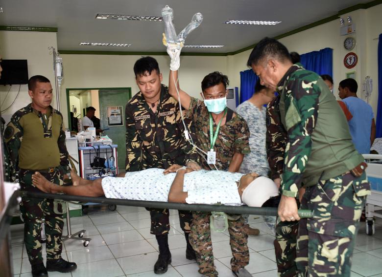A soldier lays on a stretcher and is carried by his comrades inside the Camp Bautista hospital after sustaining wounds in a gunfight with Islamic State-linked Abu Sayyaf militants in Talipao town, Sulu province, Philippines. REUTERS/Nickee Butlangan