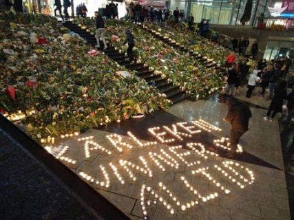 Mourners lay flowers, put candles at the scene of the Stockholm terror truck attack in the shopping district of Drottninggatan.  Photo from  Celma Mariano, Eagle News Service)