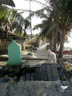 A part of the road collapses beside a marker in Tingloy, Batangas. (Photo contributed by Brother Ed Hernandez, Eagle News Service) 