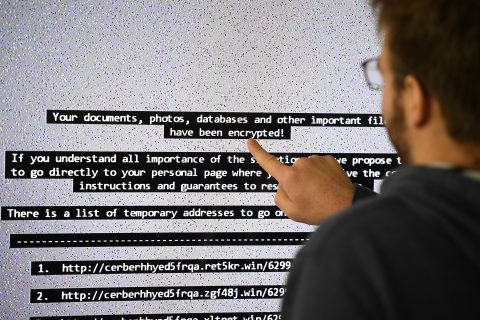 An IT researchers shows on a giant screen a computer infected by a ransomware at the LHS (High Security Laboratory) of the INRIA (National Institute for Research in Computer Science and Automation) in Rennes, on November 3, 2016. Paradise where computer viruses blossom under the watchful eye of scientists, the Laboratory of high security (LHS-PEC) of Rennes is a small fortress from where emerge the first studies on the "ransomwares", those digital brigands which Dominate the malware market. / AFP PHOTO / DAMIEN MEYER