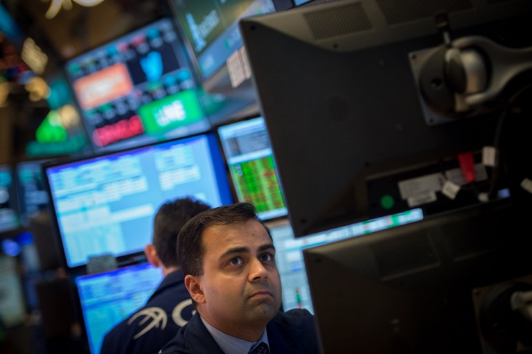 A trader works on the floor before the Dow Jones closing bell at the New York Stock Exchange, February 21, 2017 in New York. US stocks jumped with retailers and energy firms among the winners as positive sentiment about President Donald Trump's economic agenda again lifted the market to fresh records at the close. / AFP PHOTO / 30202530A / Bryan R. Smith