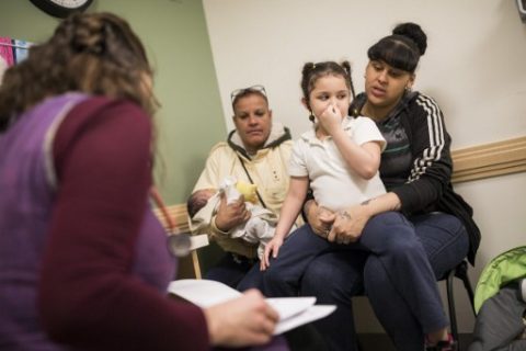 Leicha Clemente visits the pediatrician with her two children and her mother at the Esperanza Health Center in Philadelphia, PA, on March 13, 2017. The center is located in North Philadelphia, the city with the highest rate of deep poverty  people with incomes below half of the poverty line  of any of the USAs 10 most populous cities, were a high rate of people do not have medical insurance coverage. / AFP PHOTO / DOMINICK REUTER