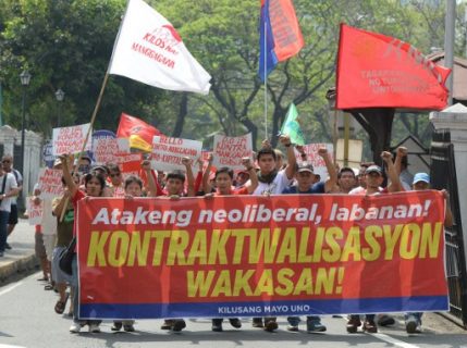 Workers hold banners as they march towards the Department of Labor and Employment (DOLE) office for a rally in Manila on March 17, 2017. The protesters are against a recently issued Department Order (DO) 174, which states, based on the labour code, as amended, the Secretary of Labor has no power to prohibit all forms of contractualization and fixed term employment. This matter is a function of legislation. The workers claim that the DO does not end, but further legitimizes contractualization, which deliberately rejected Filipino workers' demand to end all form of contractualization. / AFP PHOTO / TED ALJIBE