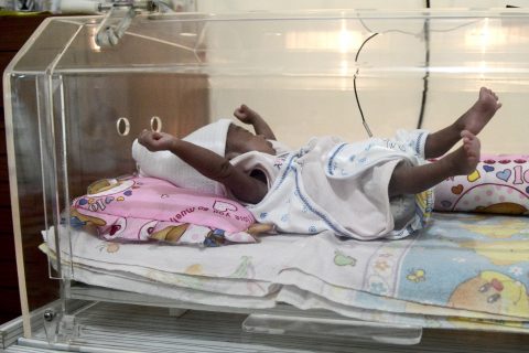 This photo taken on March 17, 2017 shows Maryamah Sudigyo, who was born prematurely, in an incubator in her home in Bogor. Maryamah is one of hundreds of premature babies born in Indonesia benefiting from the pioneering work of an engineering professor who is building incubators and lending them for free to low-income families in a bid to fill a gap in the healthcare system. Indonesia has the fifth greatest number of premature births of any nation in the world, at 675,700 a year, according to the World Health Organization. / AFP PHOTO / GOH Chai Hin / TO GO WITH Indonesia-health-technology, FEATURE by Kiki Siregar