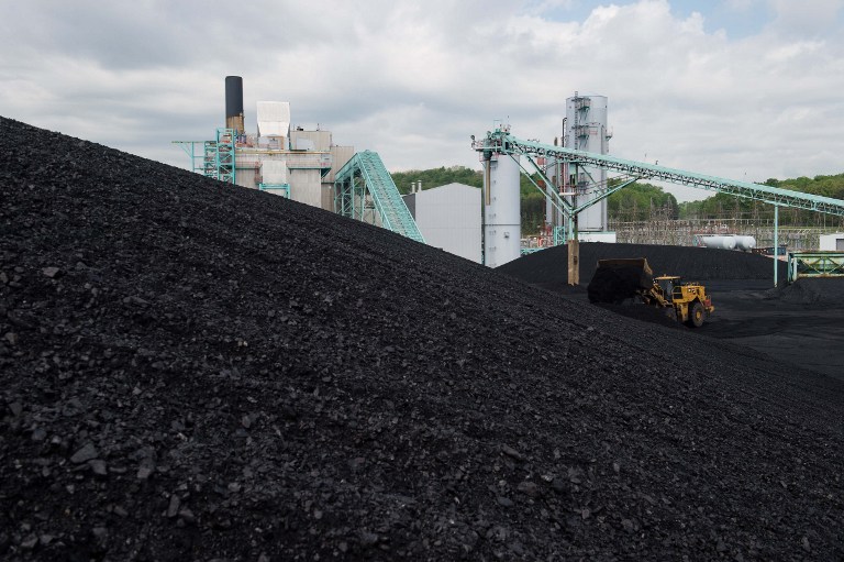 A front-end loader dumps coal at the East Kentucky Power Cooperative's John Sherman Cooper power station near Somerset, Kentucky, on April 19, 2017.  The coal-powered plant invested 250 million USD to lower its emissions but "to take a power plant like Cooper and to retrofit it with a piece of equipment that would eliminate carbon dioxide that simply doesnt exist at any cost. Were pleased that the current administration is taking a looking at the regulations, said Nick Comer, external affairs manager for East Kentucky Power Cooperative (EKPC). / AFP PHOTO / NICHOLAS KAMM