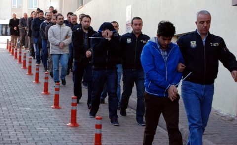 This image obtained from Dogan News Agency (DHA) shows Turkish police officers escorting people after their arrest for alleged links with US-based Muslim cleric Fethullah Gulen on April 26, 2017 in the central city of Kayseri. Turkey detained over 1,000 alleged supporters of US-based Muslim cleric Fethullah Gulen, the biggest crackdown since President Recep Tayyip Erdogan's victory in a referendum on ramping up his powers. A total of 1,009 suspects have so far been detained in raids in 72 provinces across the country, the official Anadolu news agency quoted Interior Minister Suleyman Soylu as saying. / AFP PHOTO / DOGAN NEWS AGENCY / Olcay DUZGUN / Turkey OUT
