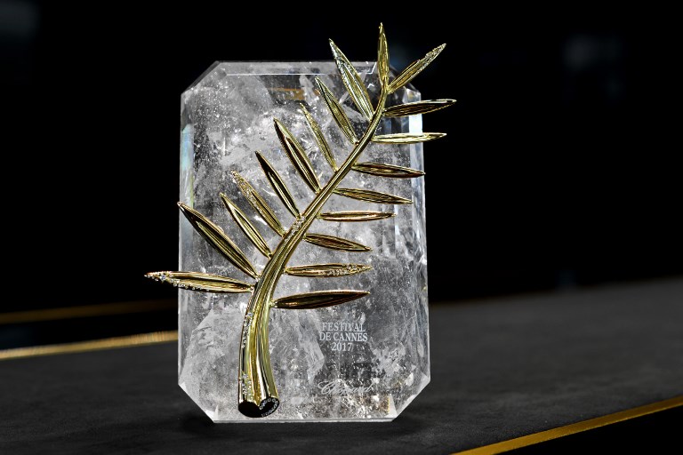 The 70th anniversary special edition of the Palme d'Or trophy is pictured ahead of the Cannes Film Festival, during a photocall at the Chopard Jewellery House on April 26, 2017 in Geneva. For the first time, the Palme d'or 2017, which will award the best film of the official selection on May 28th, will be inlaid with diamonds to celebrate the 70th edition of the Cannes Film Festival. / AFP PHOTO / Fabrice COFFRINI