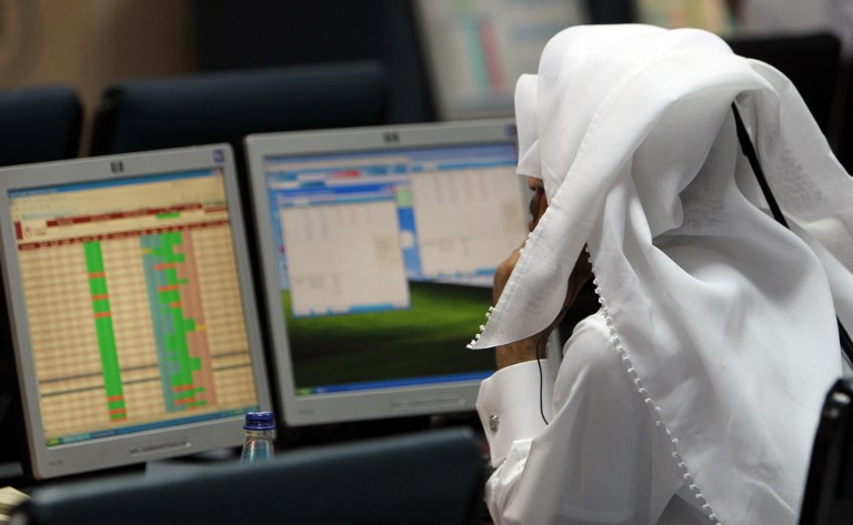 A Qatari trader follows the stock market activity at the Doha Securities Market as the index surged on December 5, 2010, the first trading day after the Gulf state won the bid to host the 2022 football World Cup and pledged to spend heavily on infrastructure. AFP PHOTO/KARIM JAAFAR / AFP PHOTO / KARIM JAAFAR