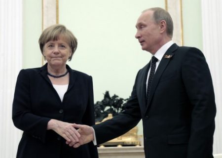 (FILES) This file photo taken on May 10, 2015 shows Russian President Vladimir Putin (R) shaking hands with German Chancellor Angela Merkel during their meeting at the Kremlin in Moscow. Putin will receive Merkel on May 2, 2017 in Sochi. / AFP PHOTO / POOL / MAXIM SHIPENKOV