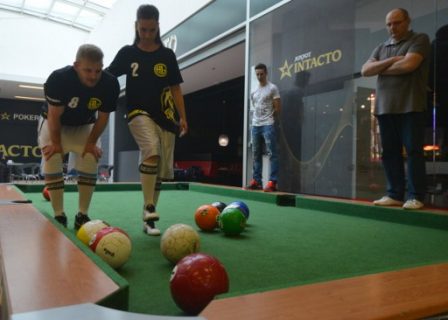 (FILES) This file photo taken on April 28, 2017 shows a man and a woman playing a footballpool match in Prague. Footballpool is a combination of football and pool, the sport uses inflatable footballs - white, solids and stripes like in pool - and a playground with six holes, proportionally larger than the regular pool table. The world's first football pool league has just kicked off in Prague, following its maiden world championships in the Czech capital in February 2017. / AFP PHOTO / Michal Cizek / TO GO WITH AFP STORY by JAN FLEMR