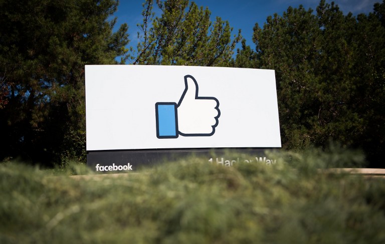 (FILES) This file photo taken on November 4, 2016 shows the Facebook sign and logo in Menlo Park, California. Facebook said on May 3, 2017, it would add 3,000 people to screen out violent content as the social media giant faces scrutiny for a series of killings and suicides broadcast on its platform. "If we're going to build a safe community, we need to respond quickly," chief executive Mark Zuckerberg said on his Facebook page. / AFP PHOTO / JOSH EDELSON