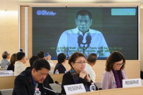 People listen to a speech delivered by Philippines' President Rodrigo Duterte shown on a screen during the universal periodic review of the Philippines by the Office of the United Nations High Commissioner for Human Rights (OHCHR) on May 8, 2017 at the UN offices in Geneva. The Philippines' record is reviewed by the UN human rights council for the first time since the inauguration of President Rodrigo Duterte, who has been accused of massive violations in his so-called drug war. / AFP PHOTO / Fabrice COFFRINI