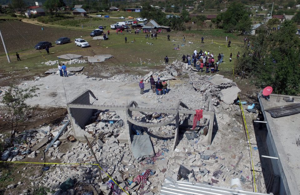 Aerial view taken from a drone showing the rubble left after a blast occurred at a fireworks warehouse in San Isidro, Chilchotla, Puebla state, Mexico on May 9, 2017. An explosion at a fireworks warehouse in Mexico has killed at least 14 people and wounded 22 in the second such tragedy in a matter of months. / AFP PHOTO / JOSE CASTAÑARES