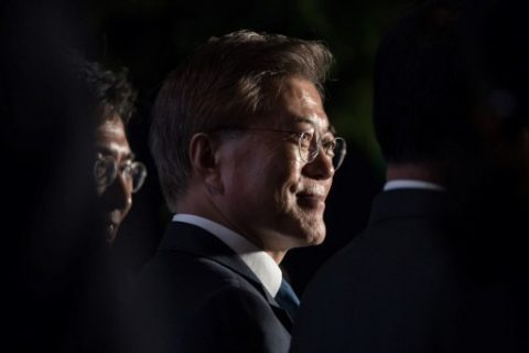 South Korean presidential candidate Moon Jae-In stands on a stage to greet supporters after exit polls suggested a landslide victory, in the central Gwanghwamun district of Seoul on May 10, 2017. South Koreans went to the polls to choose a new president after Park Geun-Hye was ousted and indicted for corruption, against a backdrop of high tensions with the nuclear-armed North. / AFP PHOTO / Ed JONES
