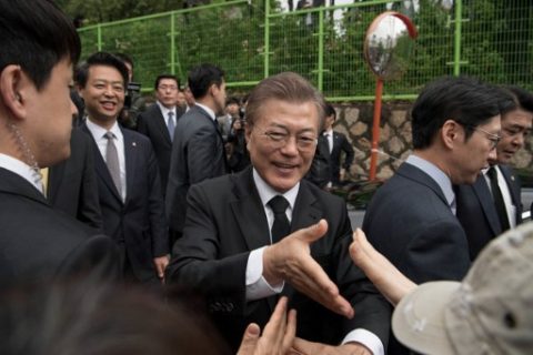 South Korean President Moon Jae-In greets supporters outside his home Seoul on May 10, 2017. Left-leaning former human rights lawyer Moon Jae-In began his five-year term as president of South Korea following a landslide election win after a corruption scandal felled the country's last leader. / AFP PHOTO / Ed JONES
