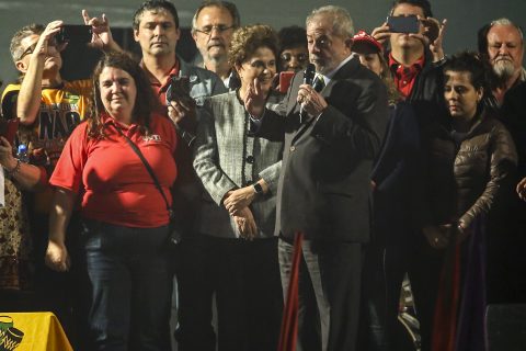 Former Brazilian President Luiz Inacio Lula Da Silva, accompanied by former Brazilian President Dilma Rousseff (2nd-L), delivers a speech for folloers in Curitiba, Brazil, on May 10, 2017. Lula, backed by hundreds of red-shirted supporters, was due in court Wednesday for a corruption trial that could end his storied career. Lula, 71, is accused of receiving a seaside apartment as a bribe in a much wider corruption scheme investigated by the so-called "Car Wash" probe upending Brazilian politics. / AFP PHOTO / Instituto LULA / Heuler Andrey