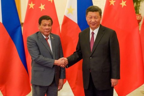 Chinese President Xi Jinping (R) shakes hands with Philippines President Rodrigo Duterte (L) prior to their bilateral meeting during the Belt and Road Forum for International Cooperation at the Great Hall of the People in Beijing on May 15, 2017. / AFP PHOTO / POOL / Etienne Oliveau