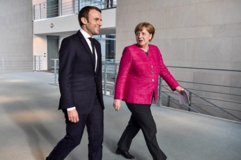 French President Emmanuel Macron (L) and German Chancellor Angela Merkel (R) arrive for a press conference following talks at the Chancellery in Berlin on May 15, 2017. France's new President Emmanuel Macron secured backing from key ally Chancellor Angela Merkel for his bid to shake up Europe, despite scepticism in Berlin over his proposed reforms. Travelling to the German capital to meet the veteran leader in his first official trip abroad, Macron used the opportunity to call for a "historic reconstruction" of Europe. / AFP PHOTO / John MACDOUGALL