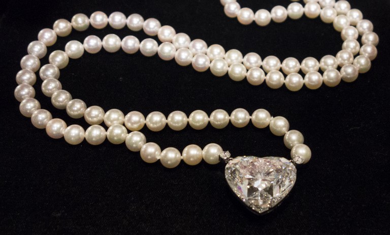 (FILES) This file photo taken on May 03, 2017 shows the 'La Légende' heart-shaped 92 carat diamond is displayed at Christie's in New York. The largest flawless heart-shaped diamond has sold for nearly USD 15 million in Geneva on May 17, 2017, breaking a world record in its category, auction house Christie's said. The 92-carat diamond forms the centre-piece of a necklace of cultured pearls. /AFP PHOTO / Don EMMERT