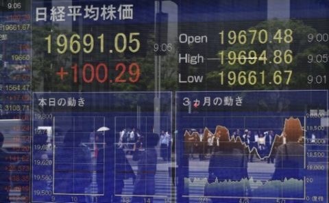 A stock quotation board displays share prices of the Tokyo Stock Exchange in front of a securities company in Tokyo on May 22, 2017. Tokyo stocks opened higher on May 22, tracking gains on Wall Street last week as higher oil prices lifted energy shares. / AFP PHOTO / Kazuhiro NOGI