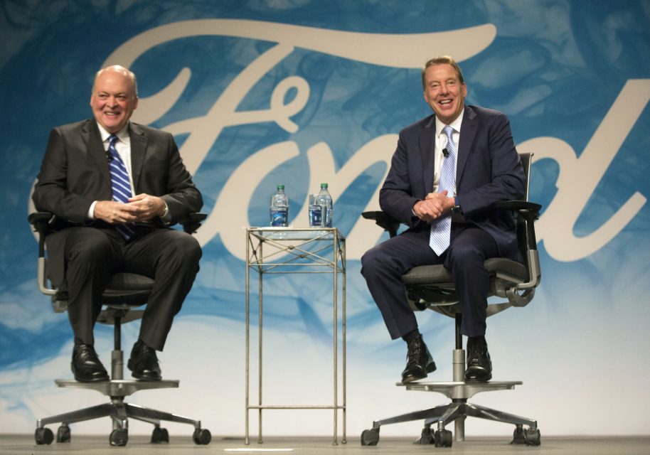 This handout photo obtained May 22, 2017 courtesy of Ford Motor Company shows Bill Ford (R) and Jim Hackett as Hackett met with employees and members of the press to discuss his appointment as president and CEO of Ford Motor Company in Dearborn, Michigan. Ford Motor Company on May 22, 2017 named Jim Hackett as president and CEO, replacing Mark Fields, as the company faces declining sales in the US and Chinese markets. The management shakeup included naming three new executive vice presidents to oversee global markets, global operation and mobility.Hackett, 62, "has a long track record of innovation and business success," Ford said in a press release.  / AFP PHOTO / FORD MOTOR COMPANY / Handout / RESTRICTED TO EDITORIAL USE - MANDATORY CREDIT "AFP PHOTO / FORD MOTOR COMPANY/HANDOUT" - NO MARKETING NO ADVERTISING CAMPAIGNS - DISTRIBUTED AS A SERVICE TO CLIENTS
