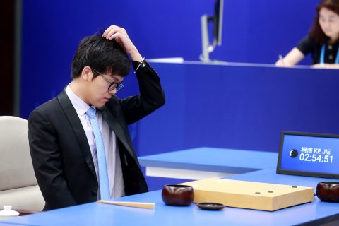 China's 19-year-old Go player Ke Jie reacts during the first match against Google's artificial intelligence programme AlphaGo in Wuzhen, east China's Zhejiang province on May 23, 2017. It's man vs machine this week from May 23 to 27 as Google's artificial intelligence programme AlphaGo faces the world's top-ranked Go player in a contest expected to end in another victory for rapid advances in AI. / AFP PHOTO / STR / China OUT