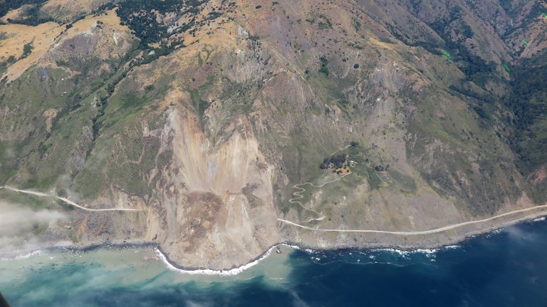This image courtesy of John Madonna Construction shows California Highway 1 covered by a landslide at Mud Creek in Monterey County on May 22, 2017. The landslide buried a stretch of California's iconic seaside Highway 1 which had already been hit by a number of road closures caused by severe winter storms, state transportation officials said May 22. The road in that section of the highway had already been shut down before a million tons of earth came tumbling down from a hillside, burying a 1,500-foot (nearly half a kilometer) section of the highway, said Jim Shivers, a spokesman for the state's transportation agency. / AFP PHOTO / John Madonna Construction / HO / RESTRICTED TO EDITORIAL USE - MANDATORY CREDIT "AFP PHOTO / Courtesy of John Madonna Construction" - NO MARKETING NO ADVERTISING CAMPAIGNS - DISTRIBUTED AS A SERVICE TO CLIENTS