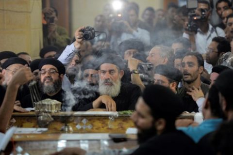 Relatives of killed Coptic Christians grieve as they gather during the funeral at Abu Garnous Cathedral in the north Minya town of Maghagha, on May 26, 2017. Egypt launched an air strike on a jihadist training camp after masked gunmen attacked a bus of Coptic Christians south of the Egyptian capital, killing at least 28 people. / AFP PHOTO / MOHAMED EL-SHAHED