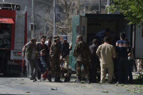 EDITORS NOTE: Graphic content / A car bomb attack victim is carried to an ambulance at the site of the blast in Kabul on May 31, 2017. A massive blast rocked Kabul's diplomatic quarter during the morning rush hour on May 31, the latest attack to hit the Afghan capital. / AFP PHOTO / SHAH MARAI